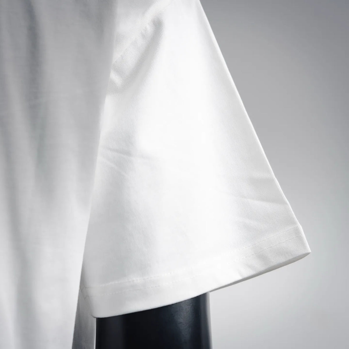 White T-shirt side profile with short sleeves and stitched hem