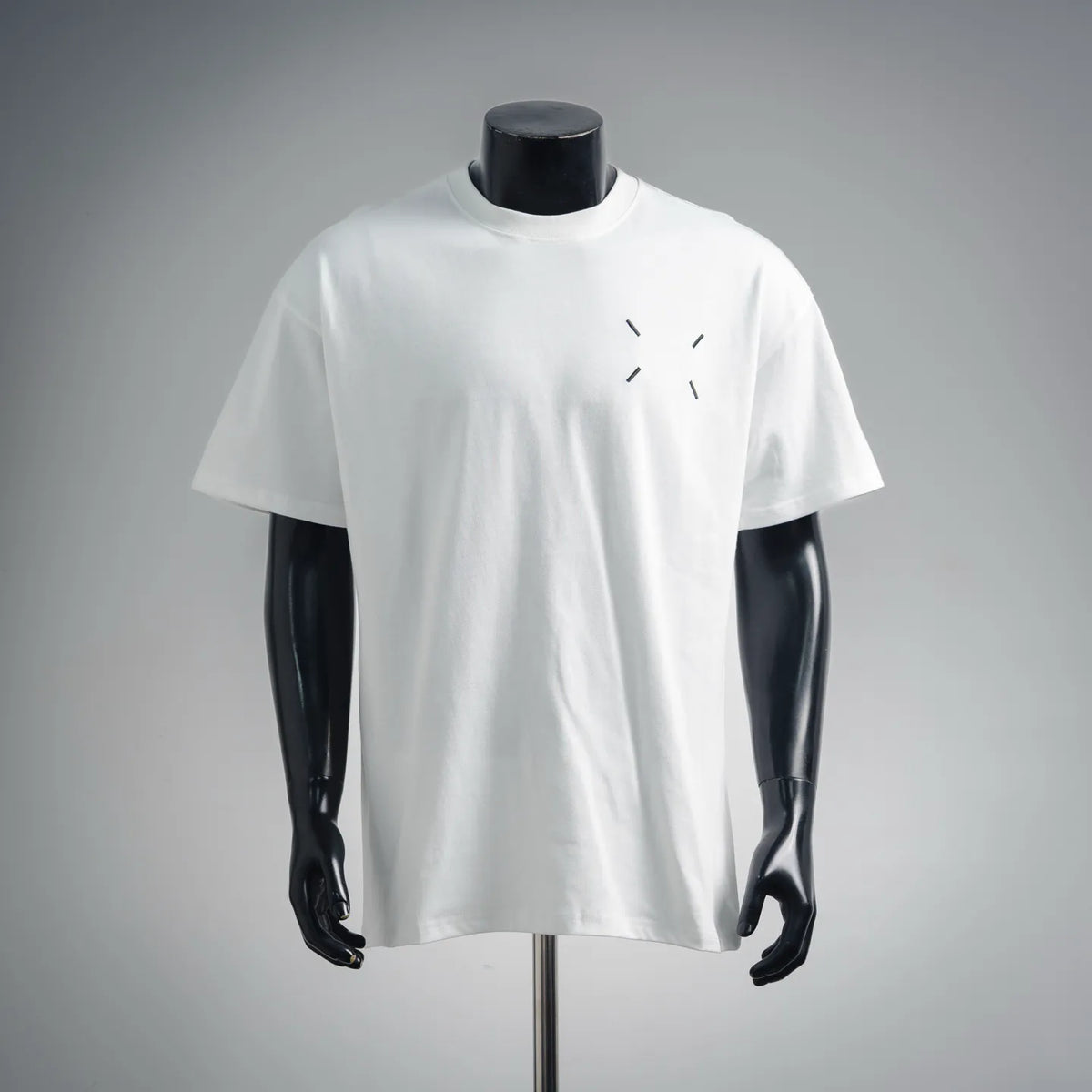 White short-sleeve T-shirt with small black logo graphic on chest