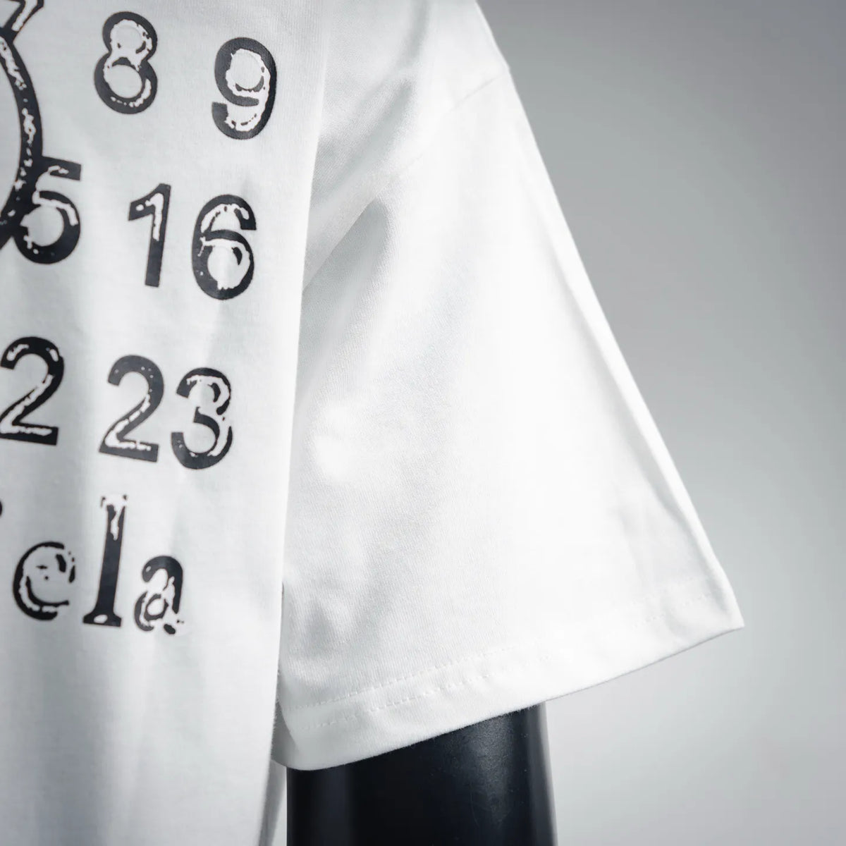 White T-shirt with black numeric logo print on the front