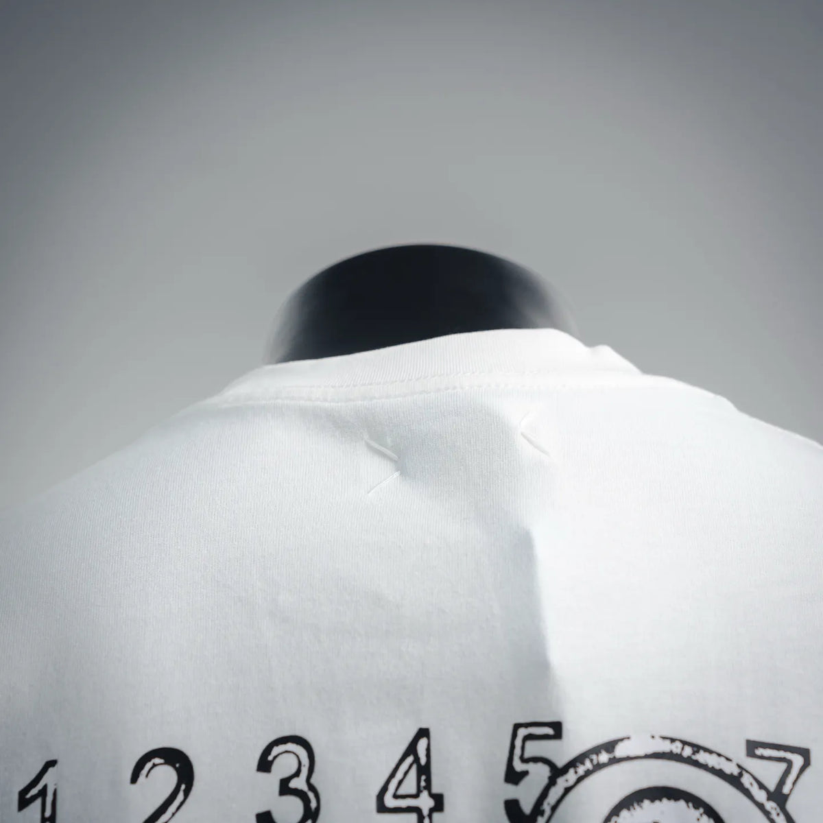 White T-shirt back with Maison Margiela logo graphic near the neckline