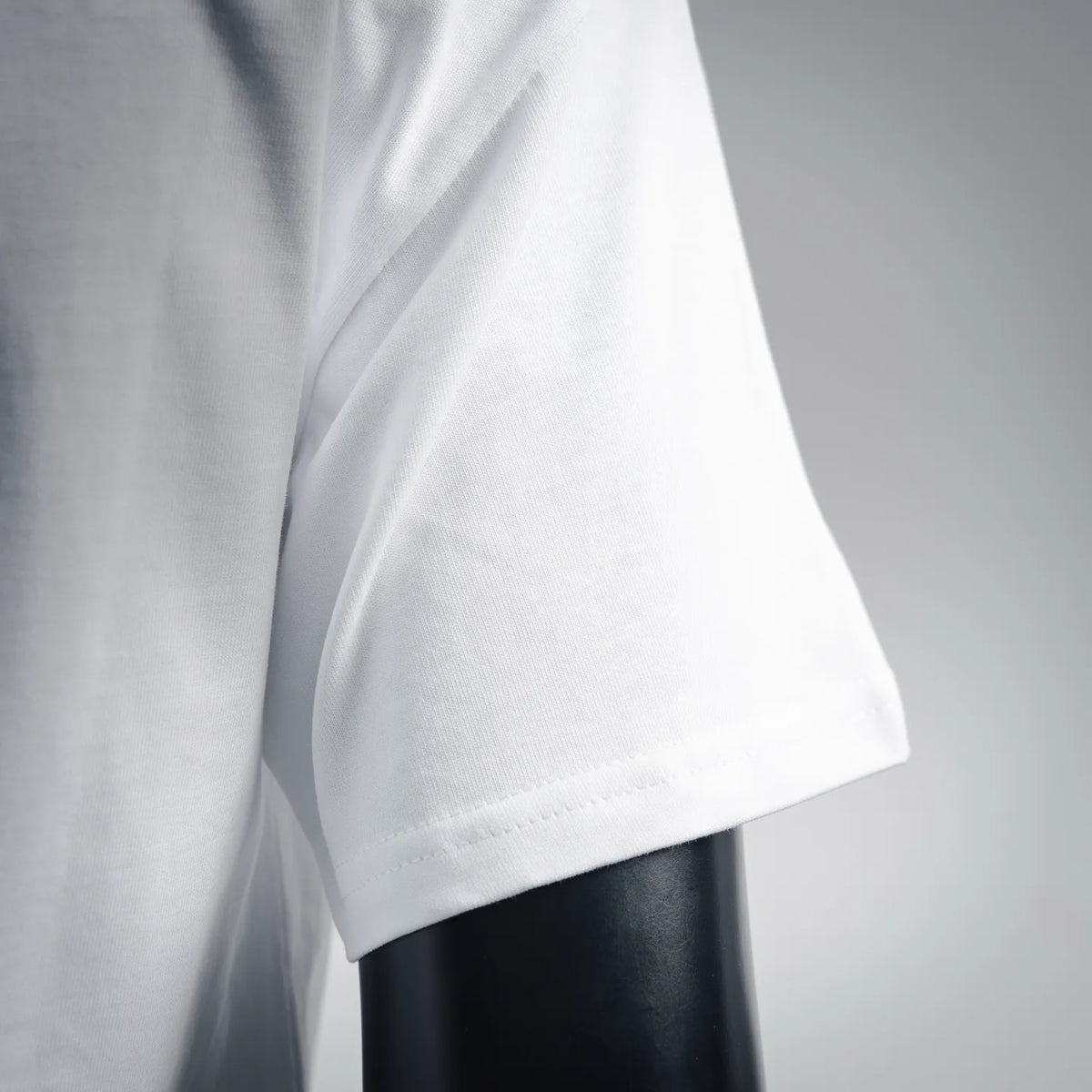 White short-sleeve T-shirt side close-up with sleeve seam and soft drape