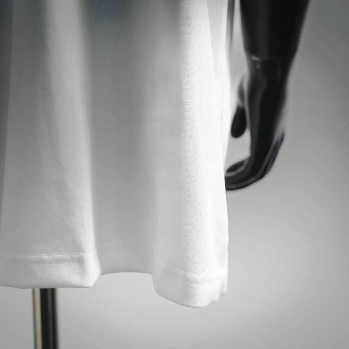 White short-sleeve T-shirt hem detail with soft drape
