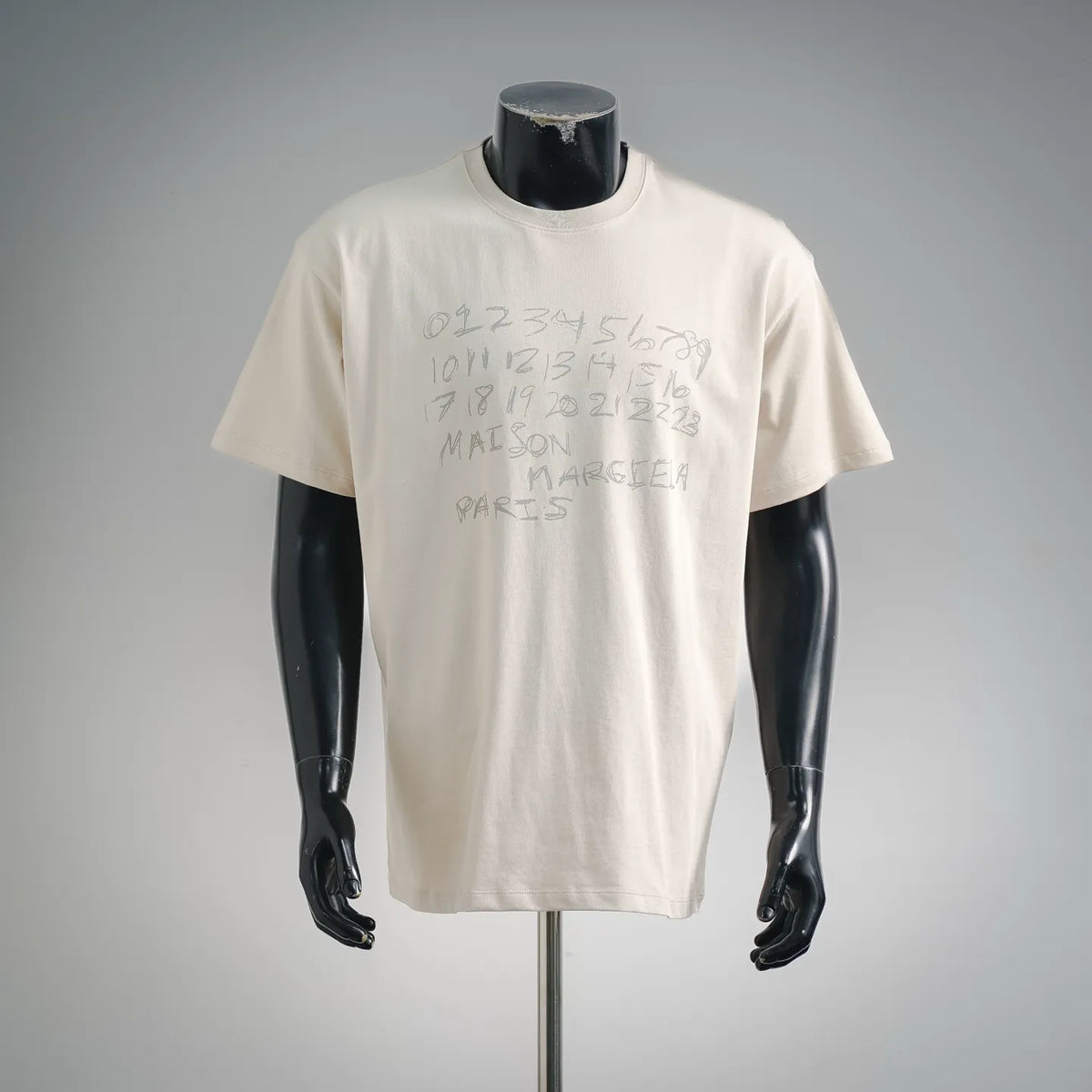 White short-sleeve T-shirt with abstract number graphic on front