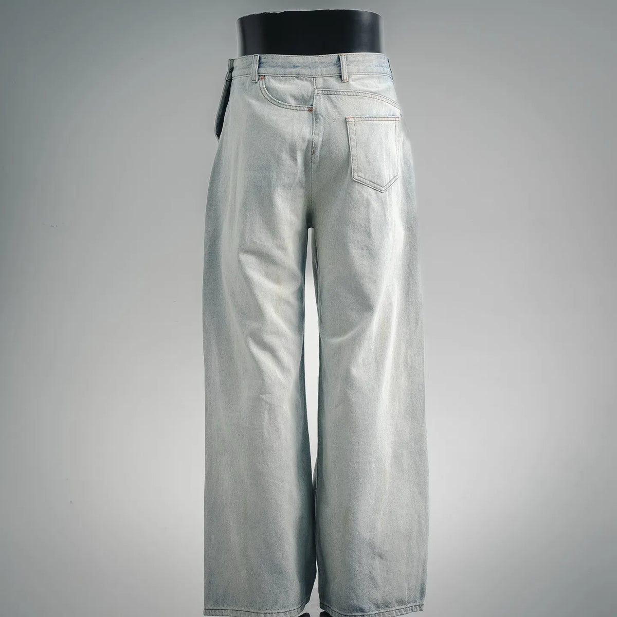 Light-wash denim pants with button-and-zip front, slanted pockets, wide-leg fit