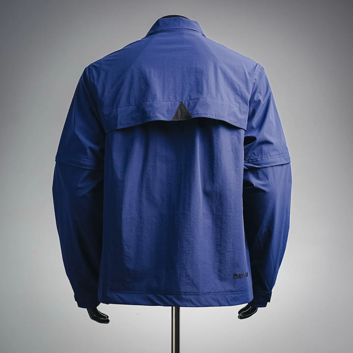 Blue long-sleeve jacket back view with stand collar and button cuff details