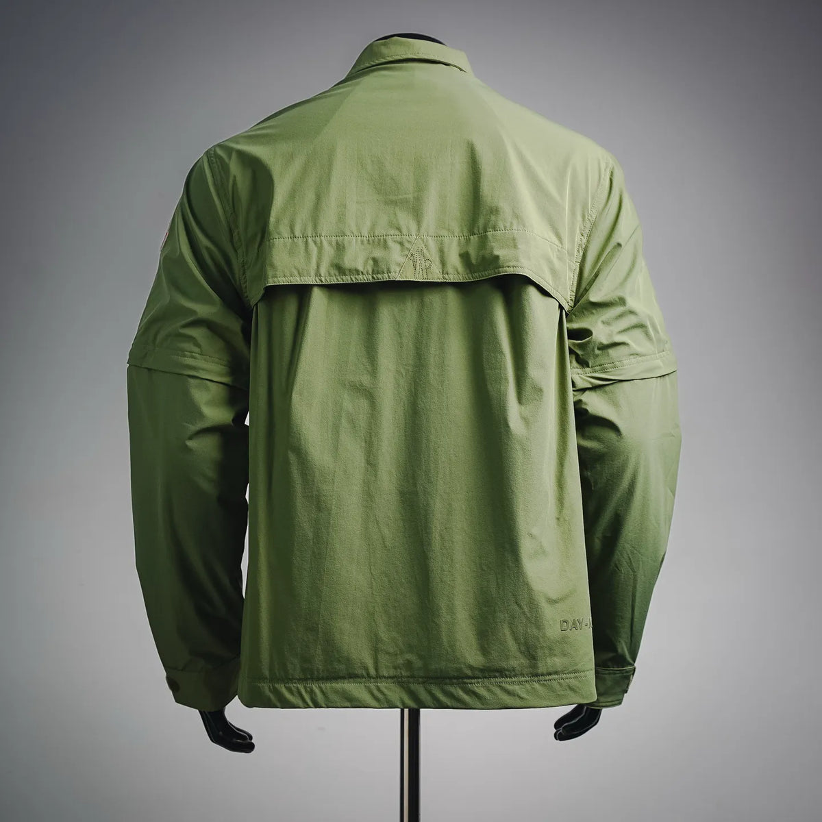 Moncler long green jacket back view with top yoke and back pleat