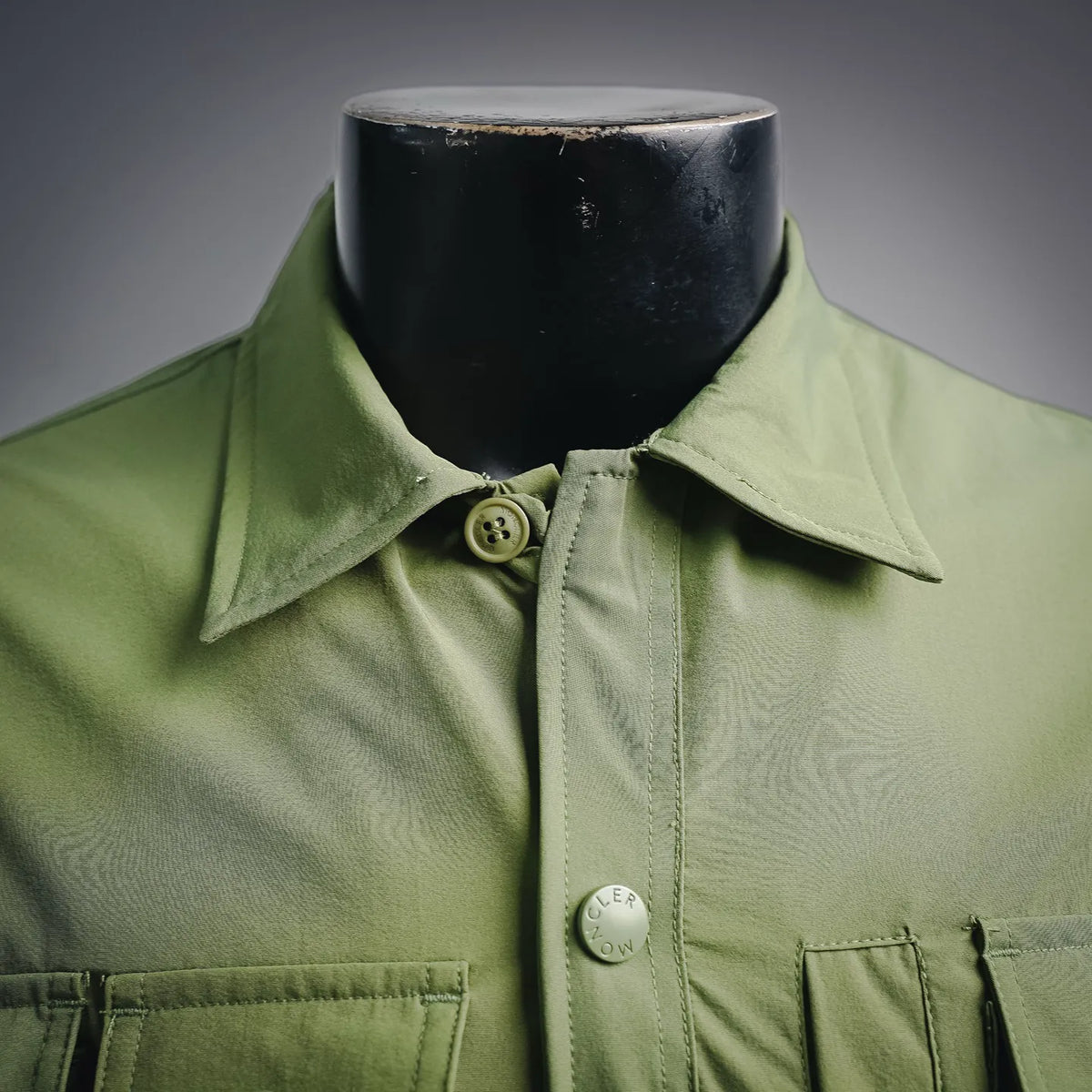 Moncler long green jacket collar with button closure and chest emblem