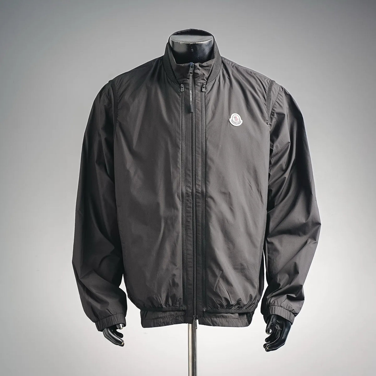 Moncler coat in dark gray, full-zip front with stand collar and chest logo patch