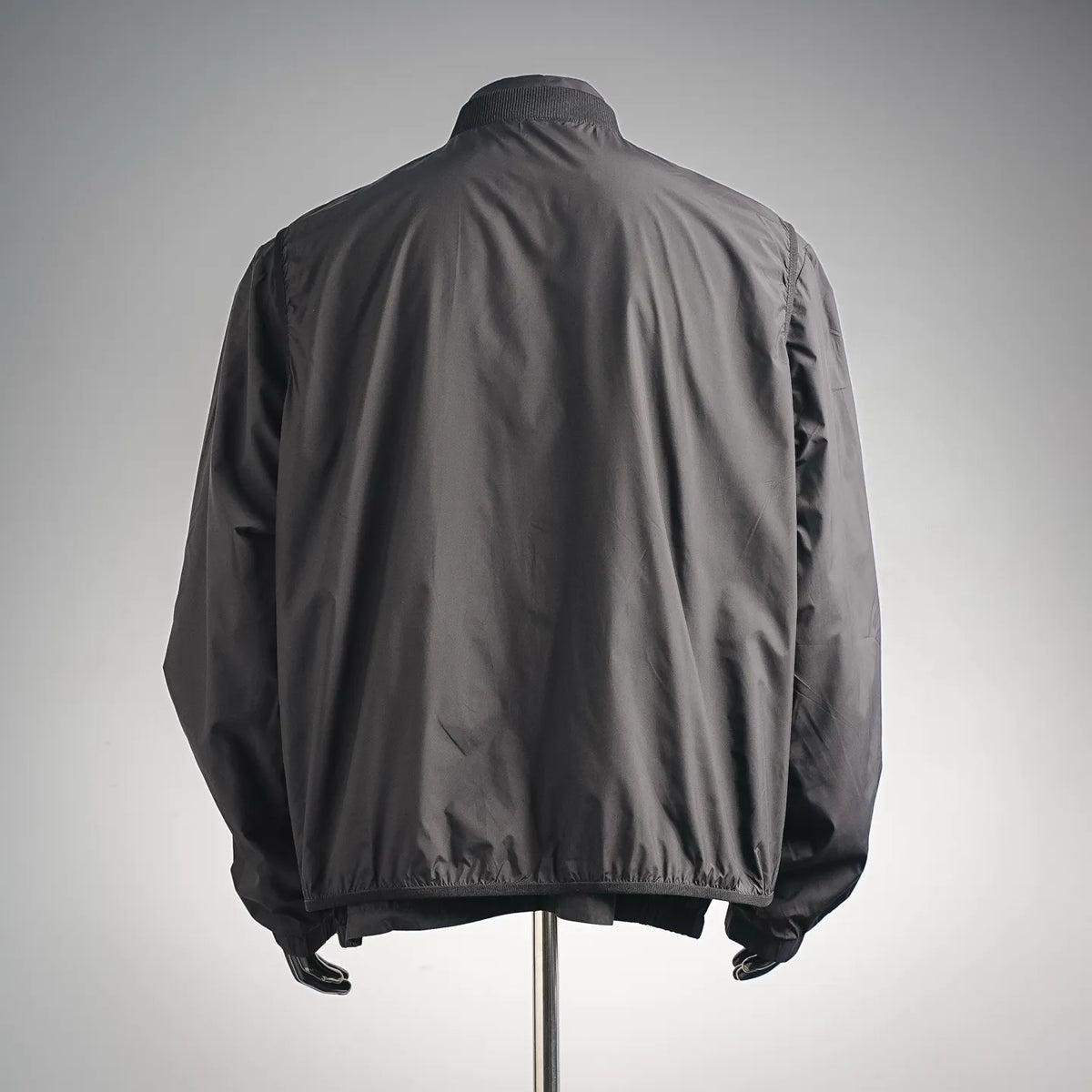 Moncler coat back view with stand collar and elastic hem