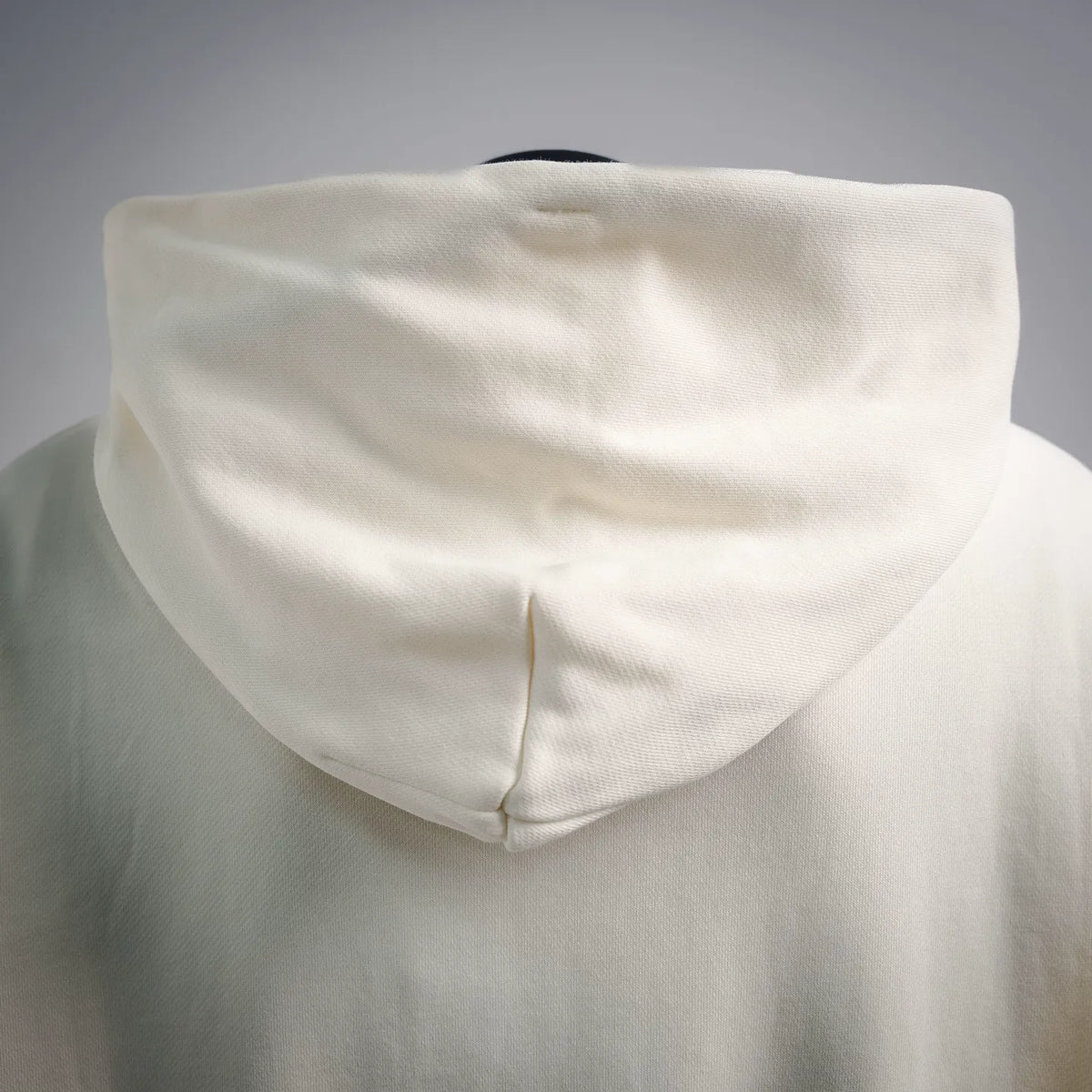 Cream pullover hoodie with draped hood and front seam detail
