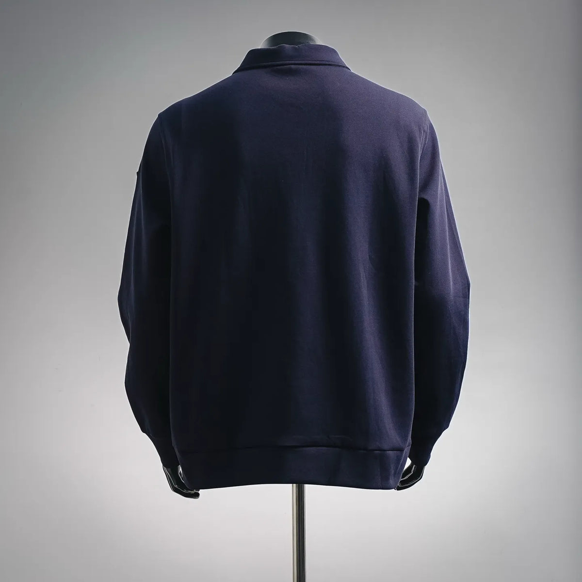 Moncler zip-up coat, back view, dark navy-purple, ribbed hem and cuffs.