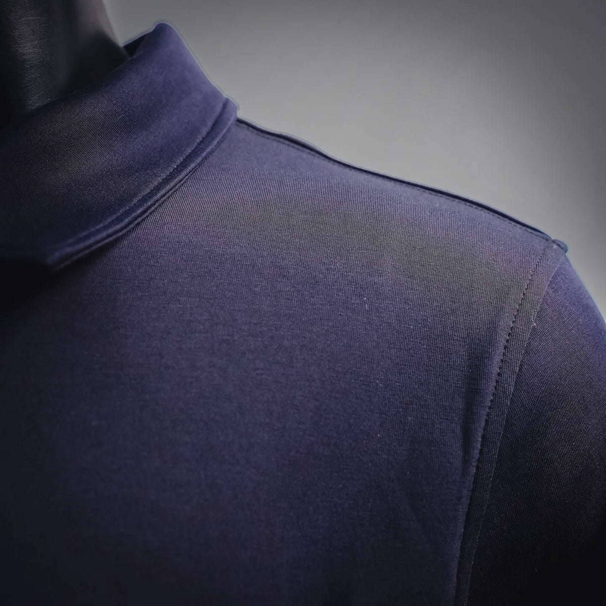 Moncler coat shoulder and arm seam, dark navy-purple knit fabric.