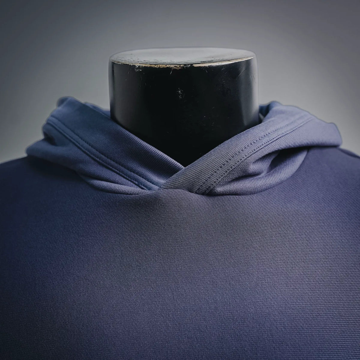 Navy hoodie neckline with overlapping hood and drawstring