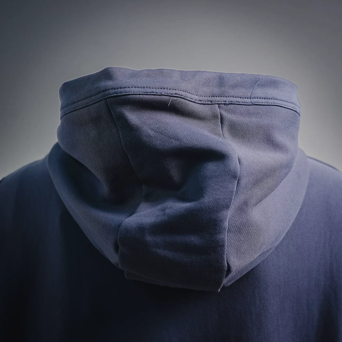 Navy pullover hoodie hood with ribbed trim, back close-up