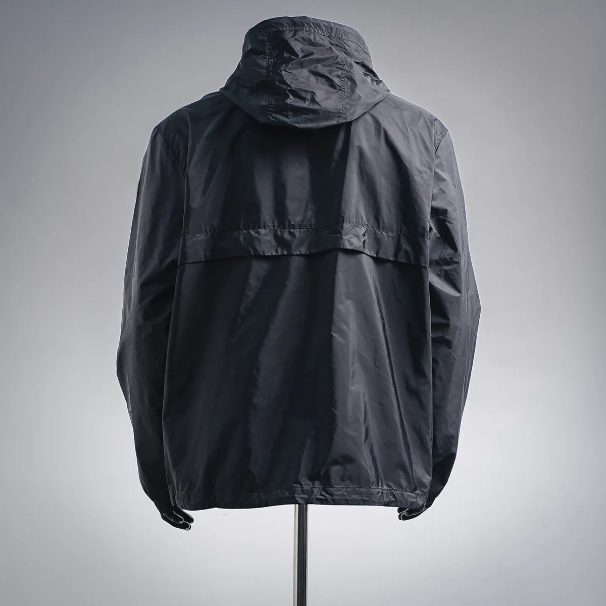 Dark Moncler hooded coat, back view with structured yoke and ribbed hem