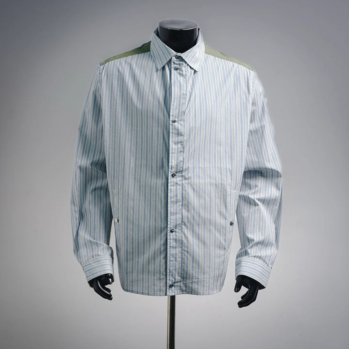 Reversible long-sleeve button-up shirt-jacket with blue vertical stripes and green trim