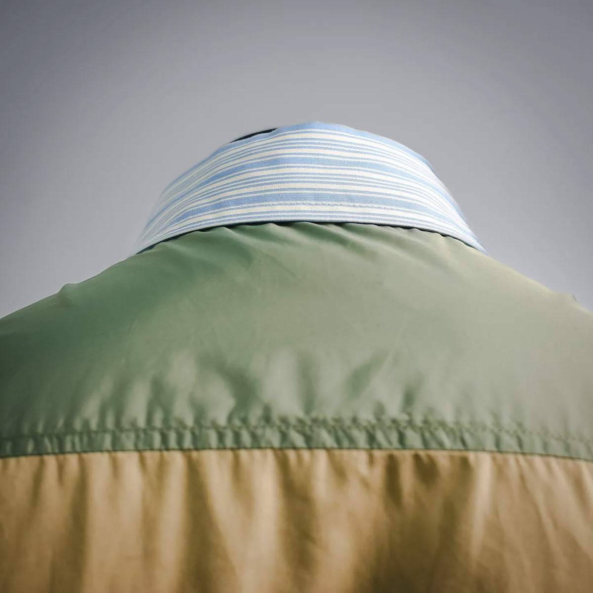 Green collar band with blue striped fabric at the neckline