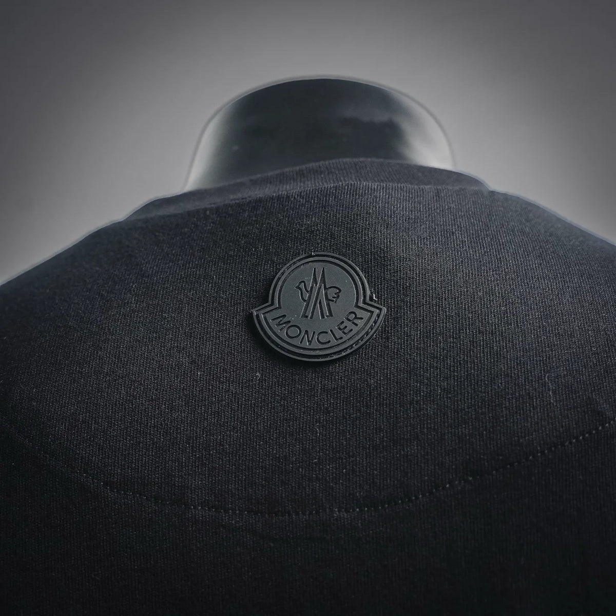 Moncler logo patch on back of black short-sleeve T-shirt