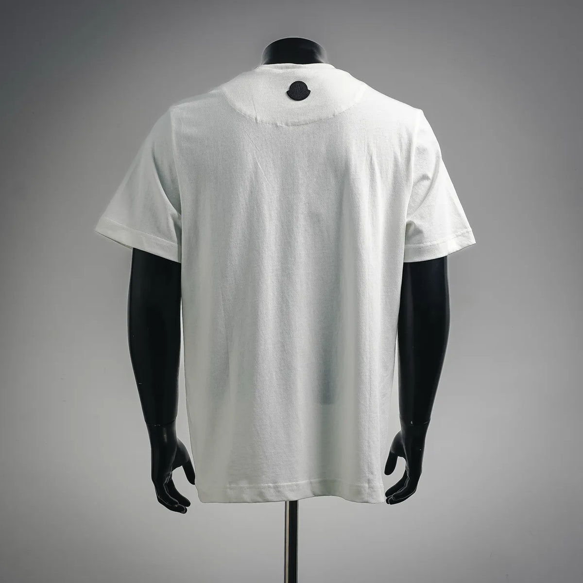 White short-sleeve T-shirt, back view with small black dot at neckline