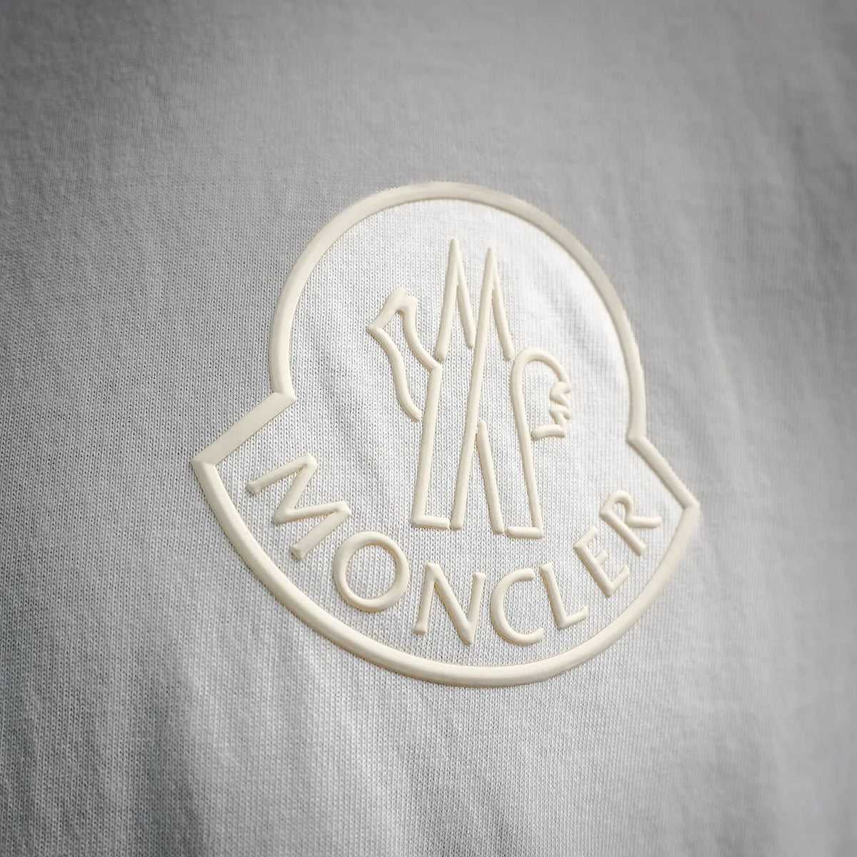 Embroidered Moncler crest and MONCLER text patch on white T-shirt chest