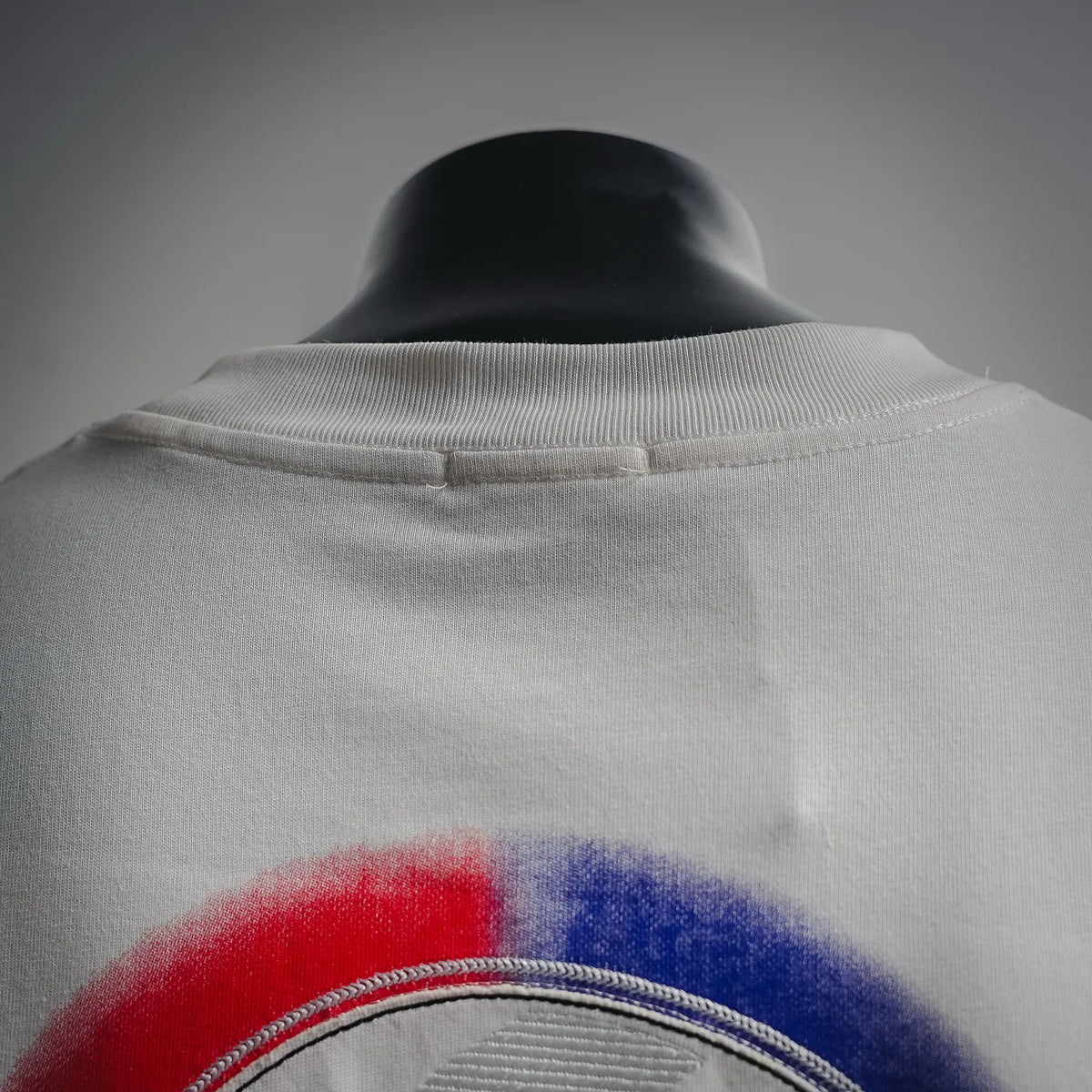 White short-sleeve crewneck T-shirt showing back neckline and logo graphic