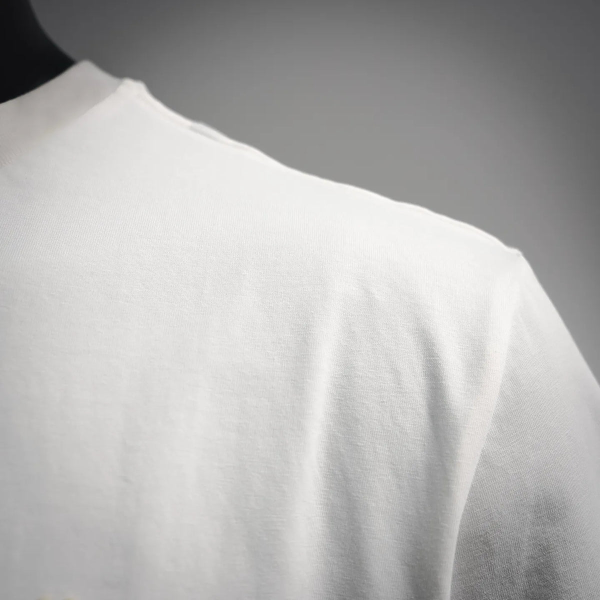 White T-shirt side and sleeve section with smooth fabric and stitching