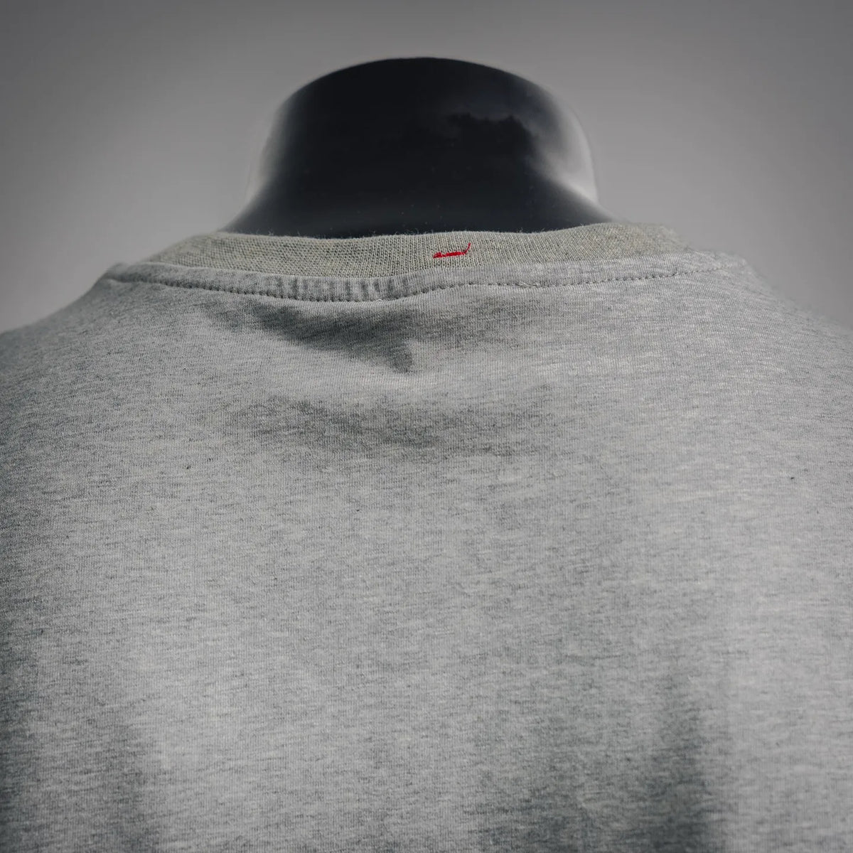Heather gray T-shirt with small embroidered logo near back neck