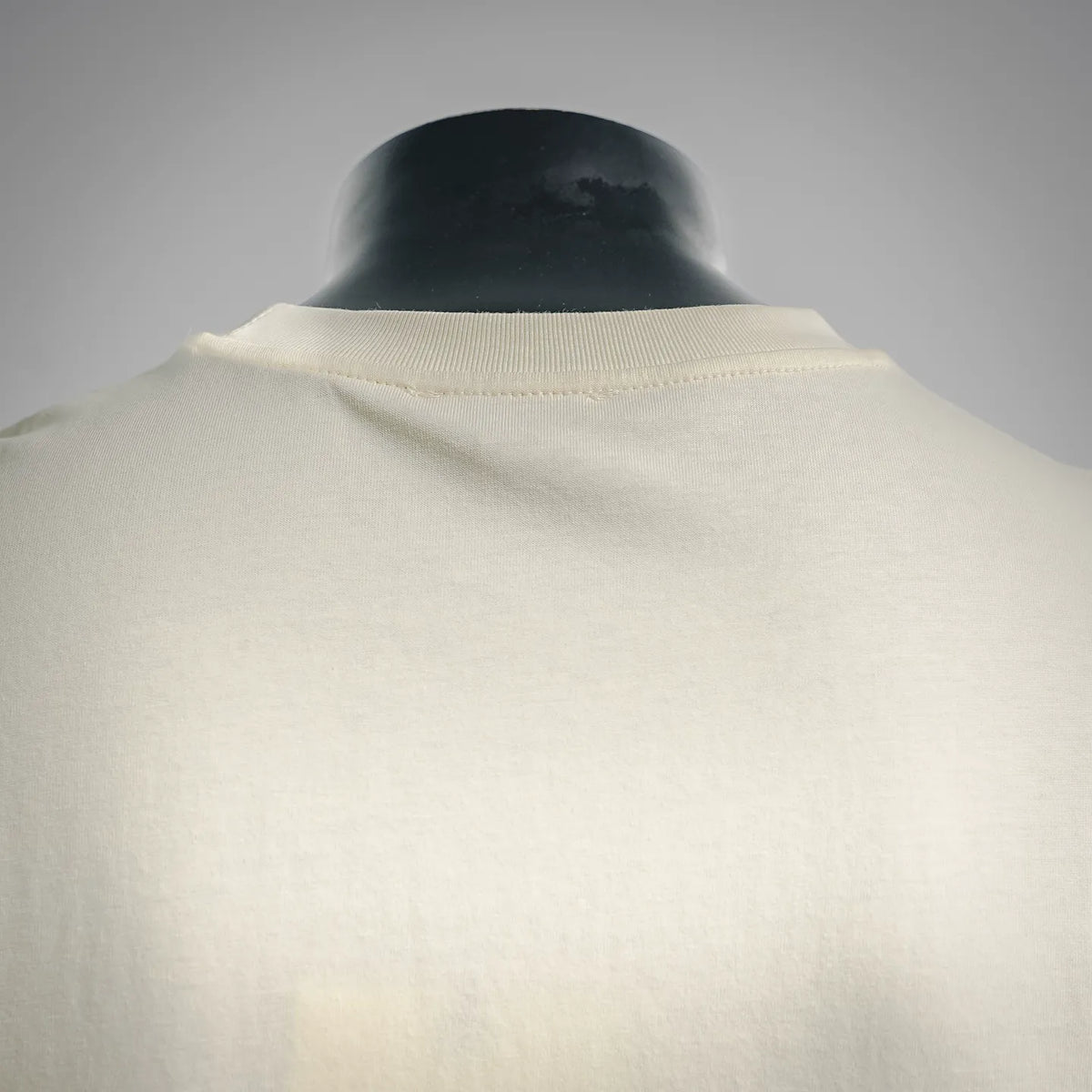 Cream crew-neck T-shirt with ribbed collar, back view