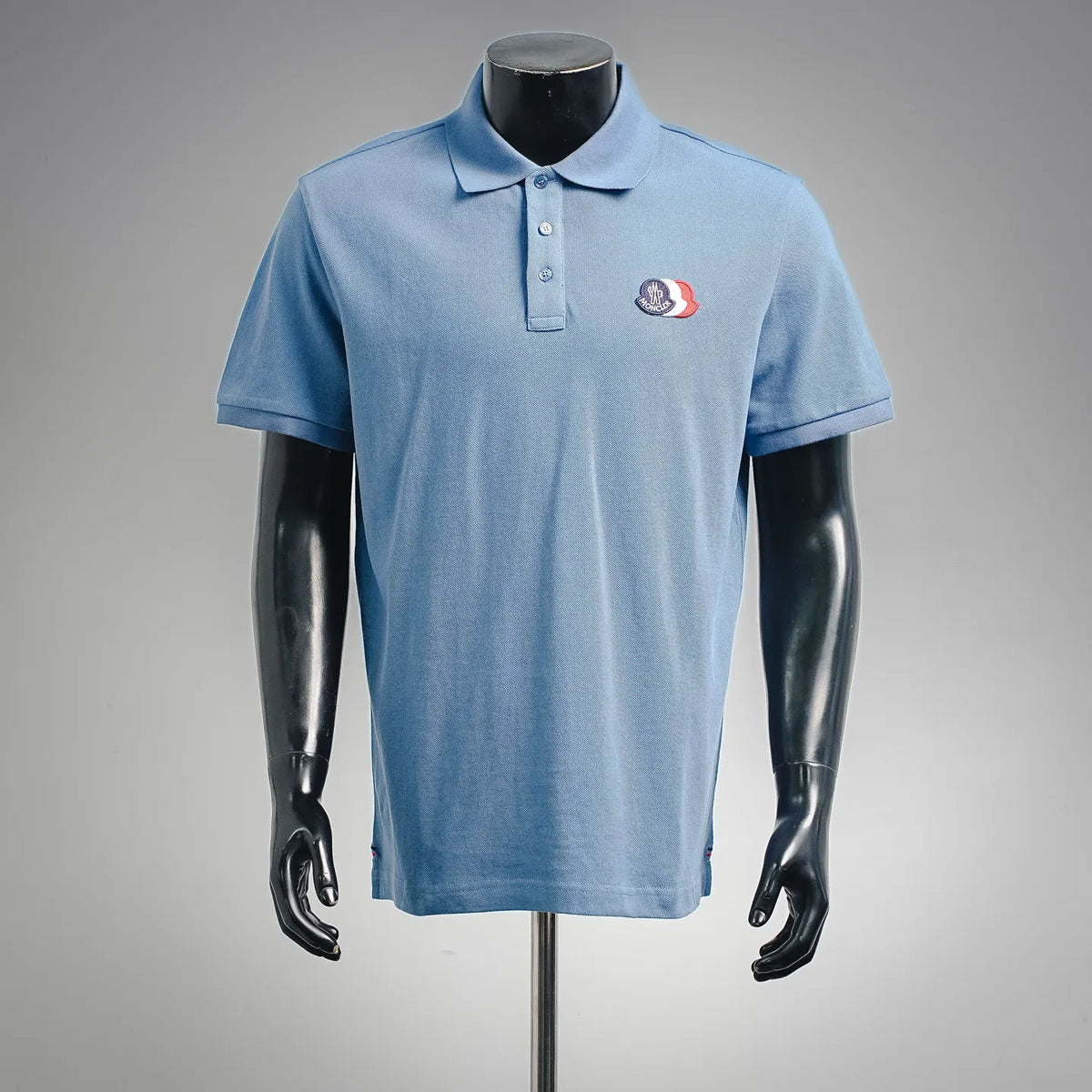 Light blue polo shirt with buttoned collar and short sleeves