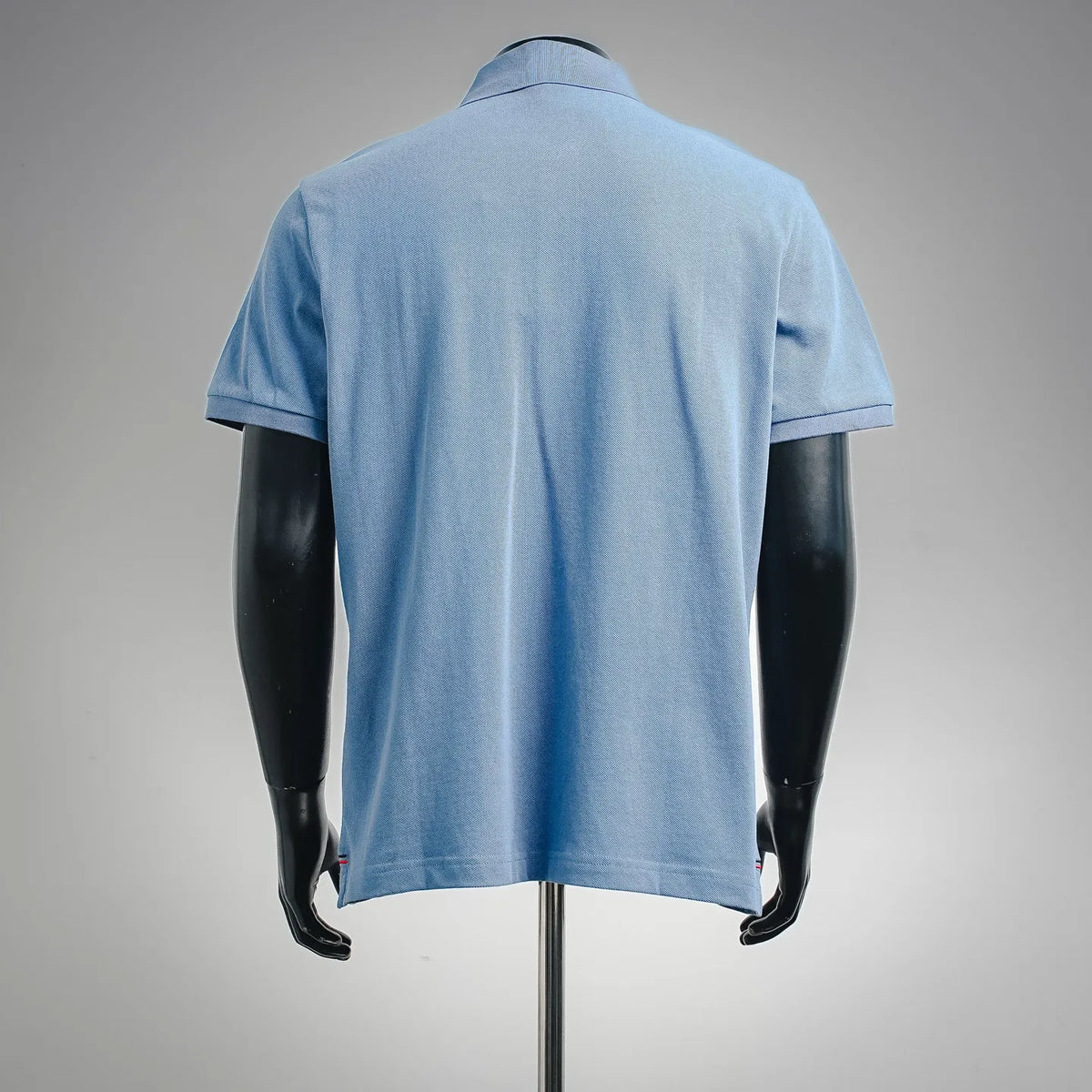 Light blue polo shirt on mannequin, back view with short sleeves