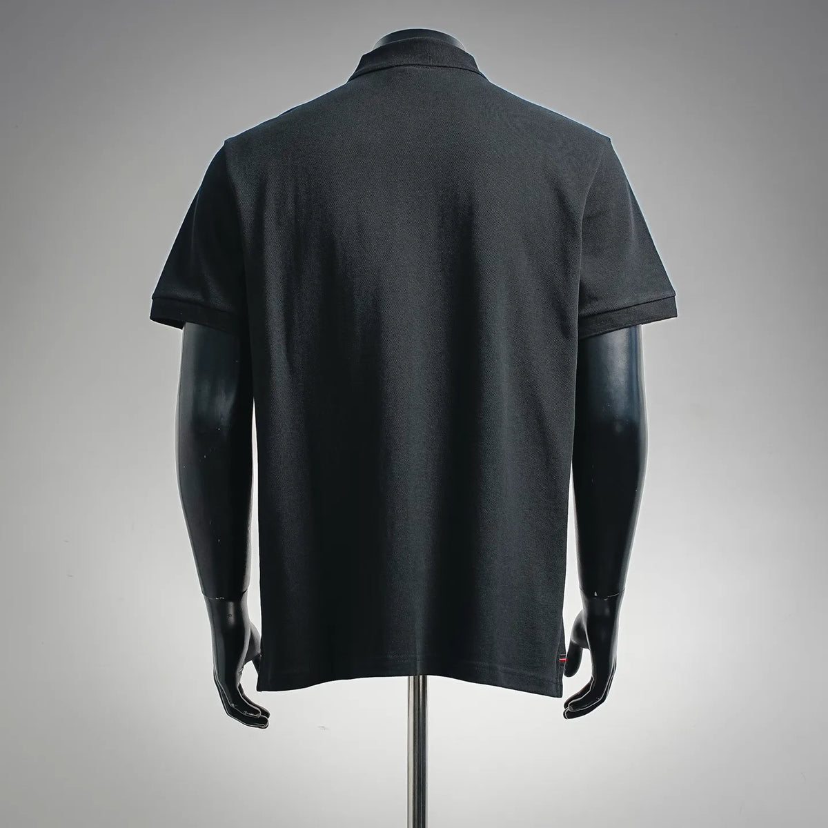 Black polo shirt with short sleeves and solid back view