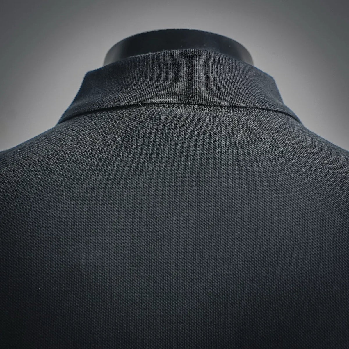 Black polo collar with ribbed neckline and textured knit fabric