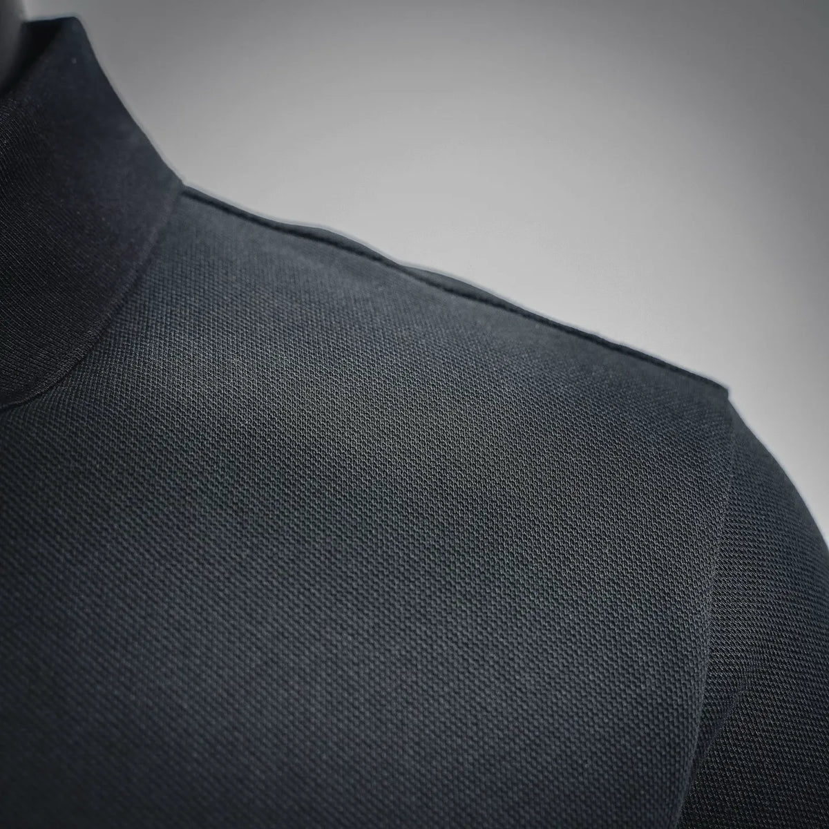 Black polo shoulder and neckline seam detail
