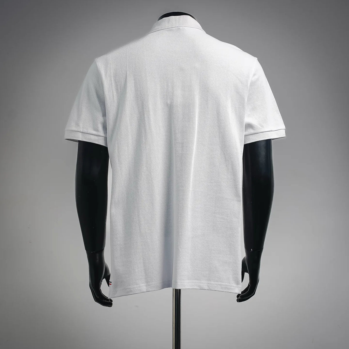 White Moncler polo shirt back view with short sleeves and clean collar
