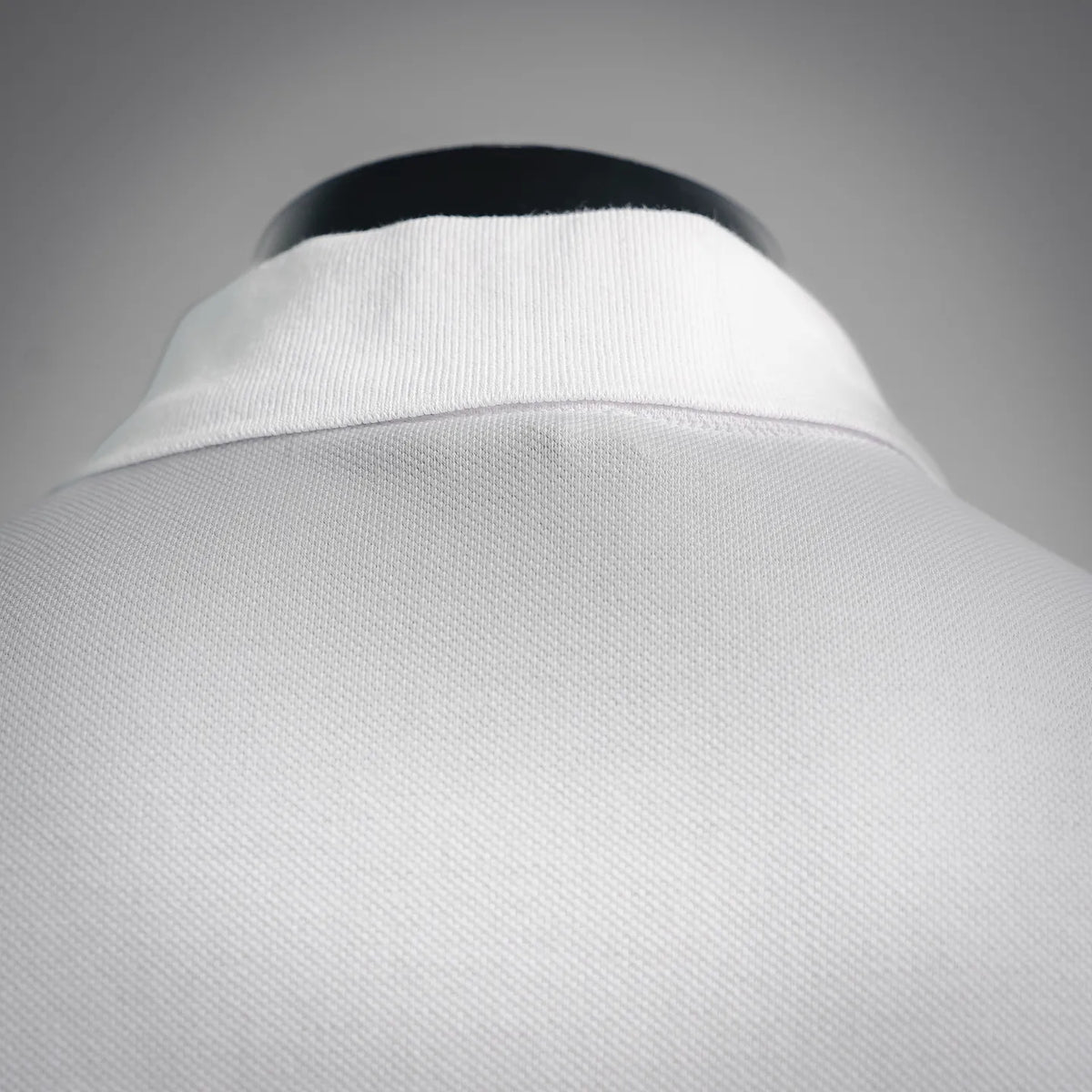 White polo shirt collar with button placket and ribbed texture