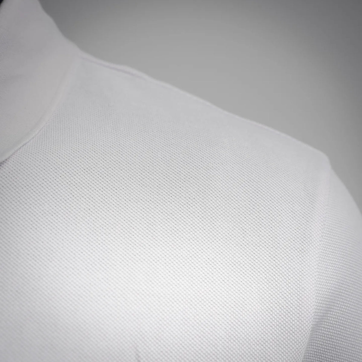 White polo shirt fabric texture with smooth knit finish