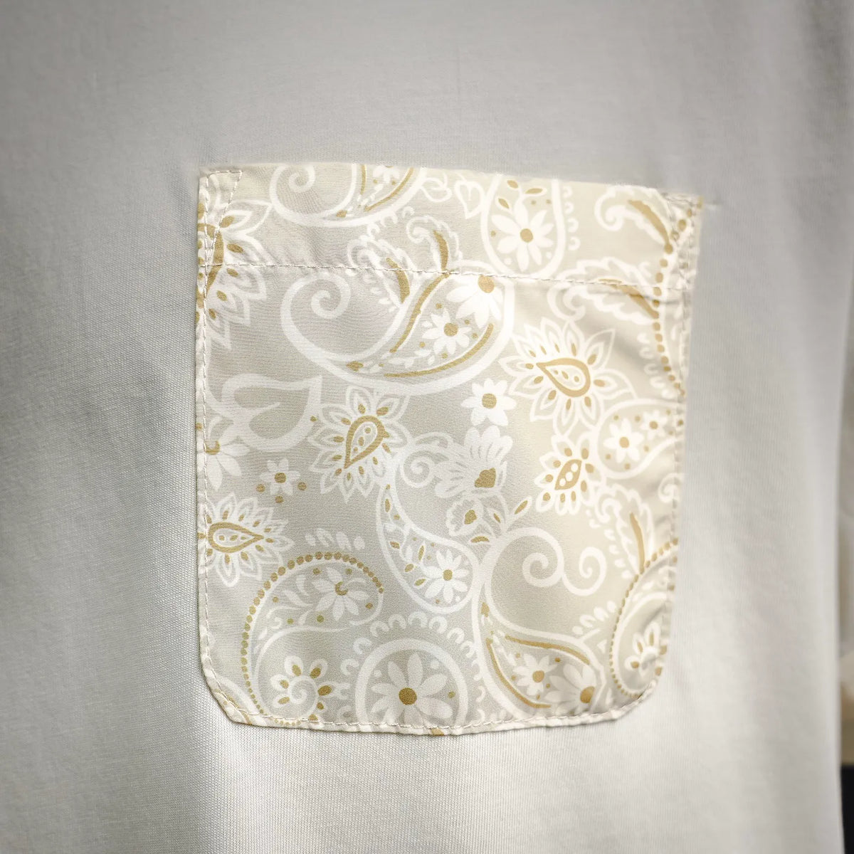 Moncler patterned fabric chest pocket panel on light cream T-shirt