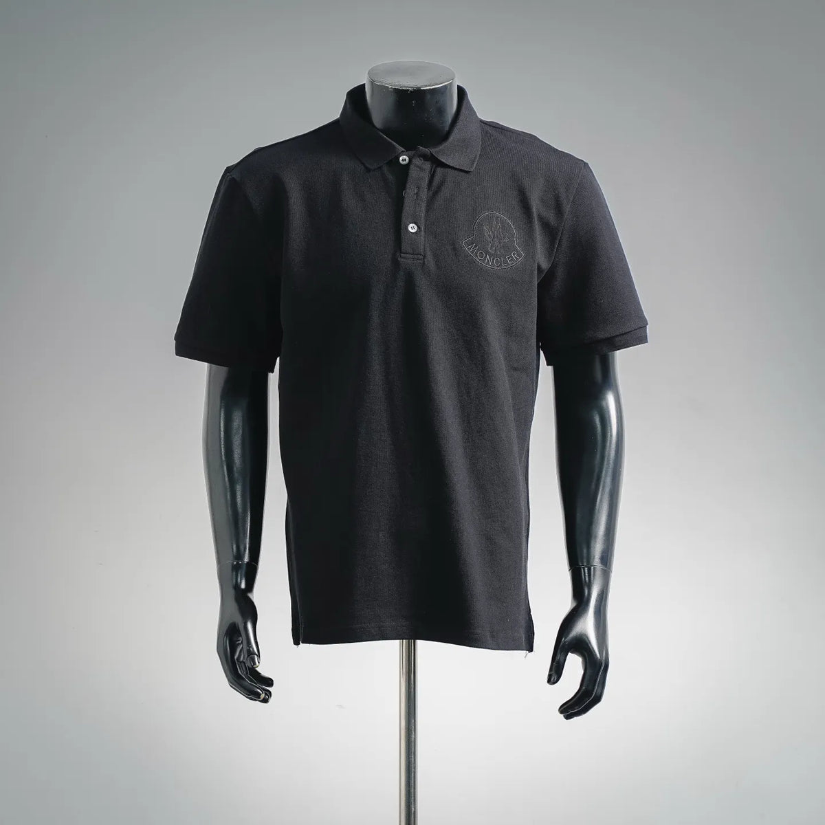 Men's Moncler short-sleeve polo shirt in dark black, embroidered chest crest logo