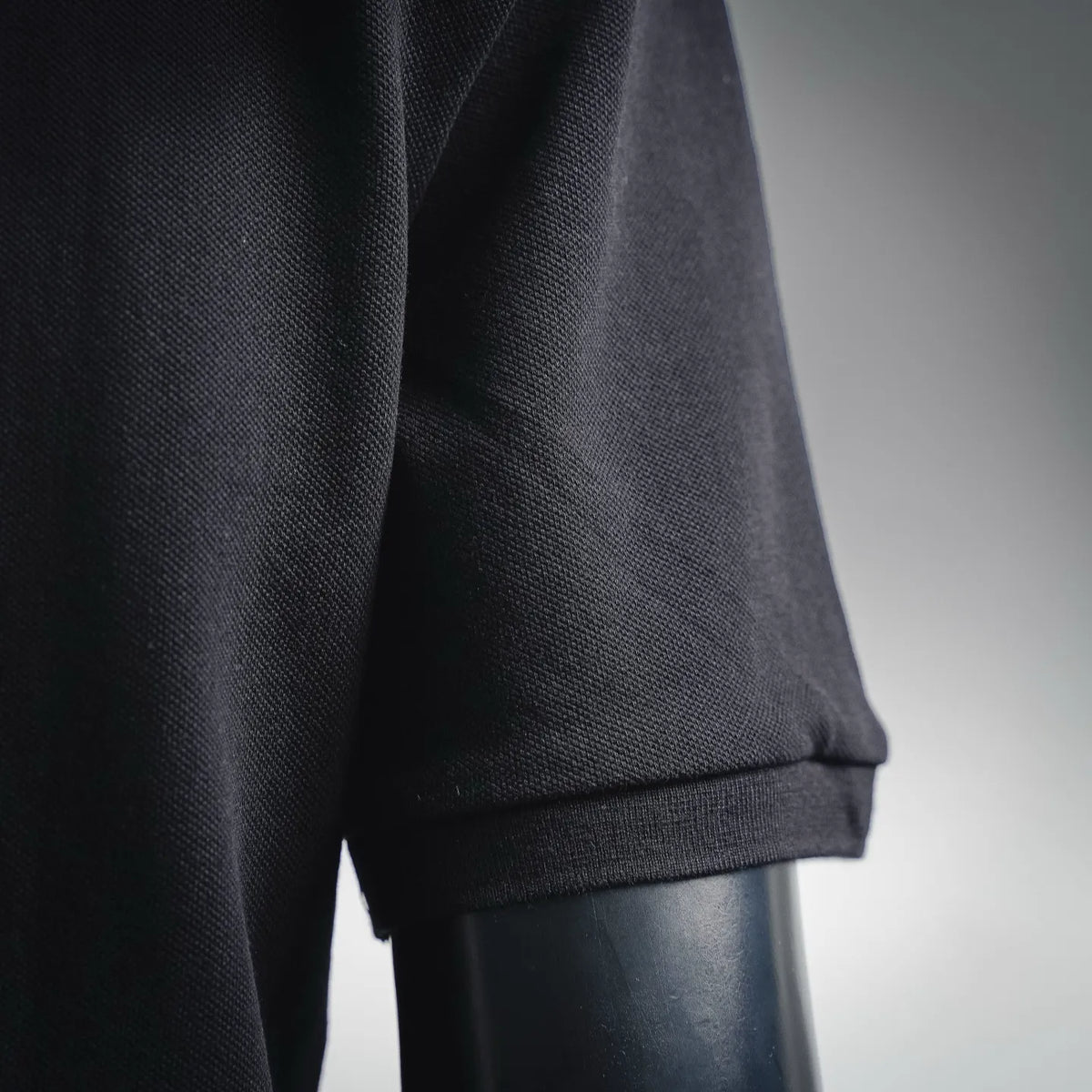 Men's Moncler polo sleeve cuff in dark black knit fabric