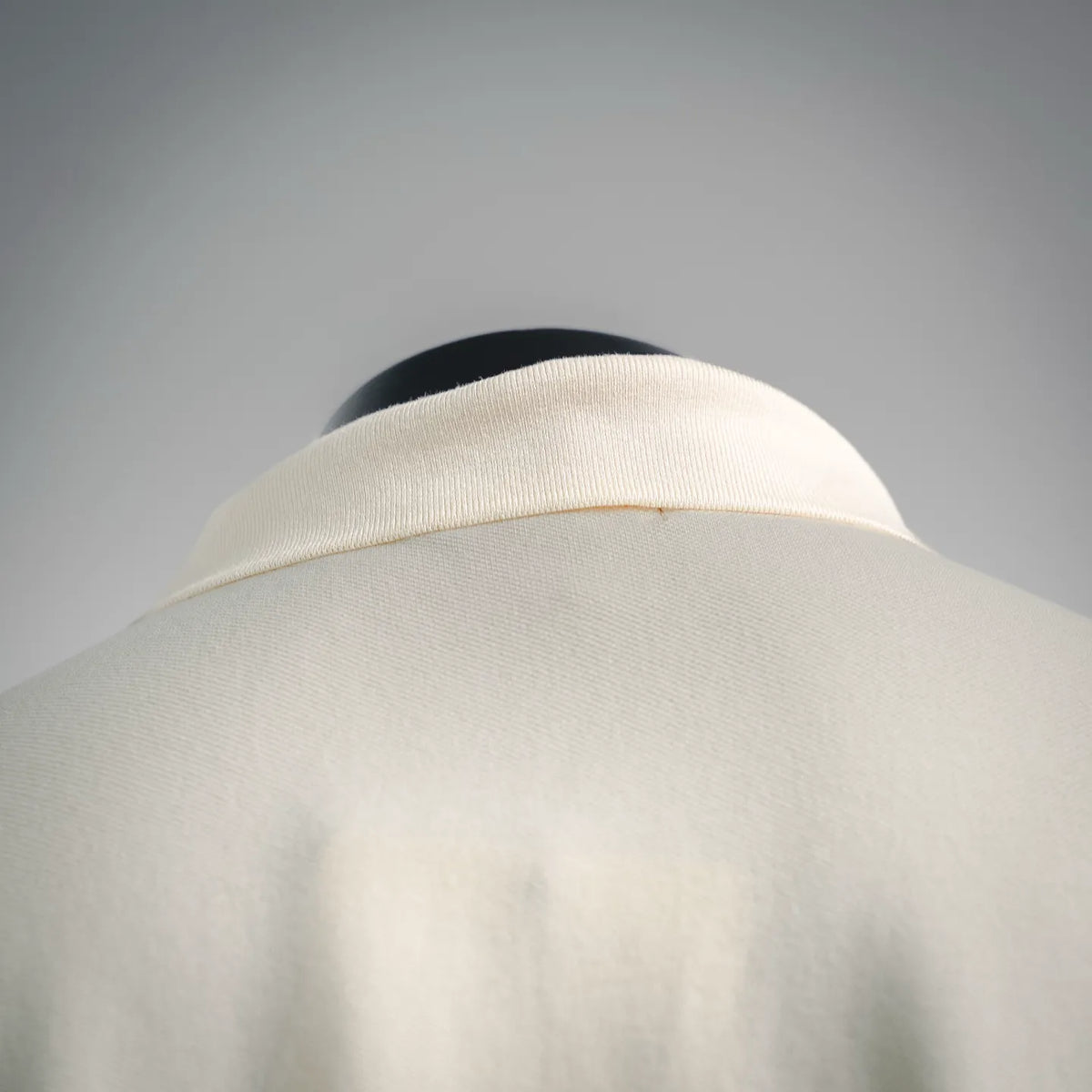 Moncler polo collar close-up, light cream ribbed neckline
