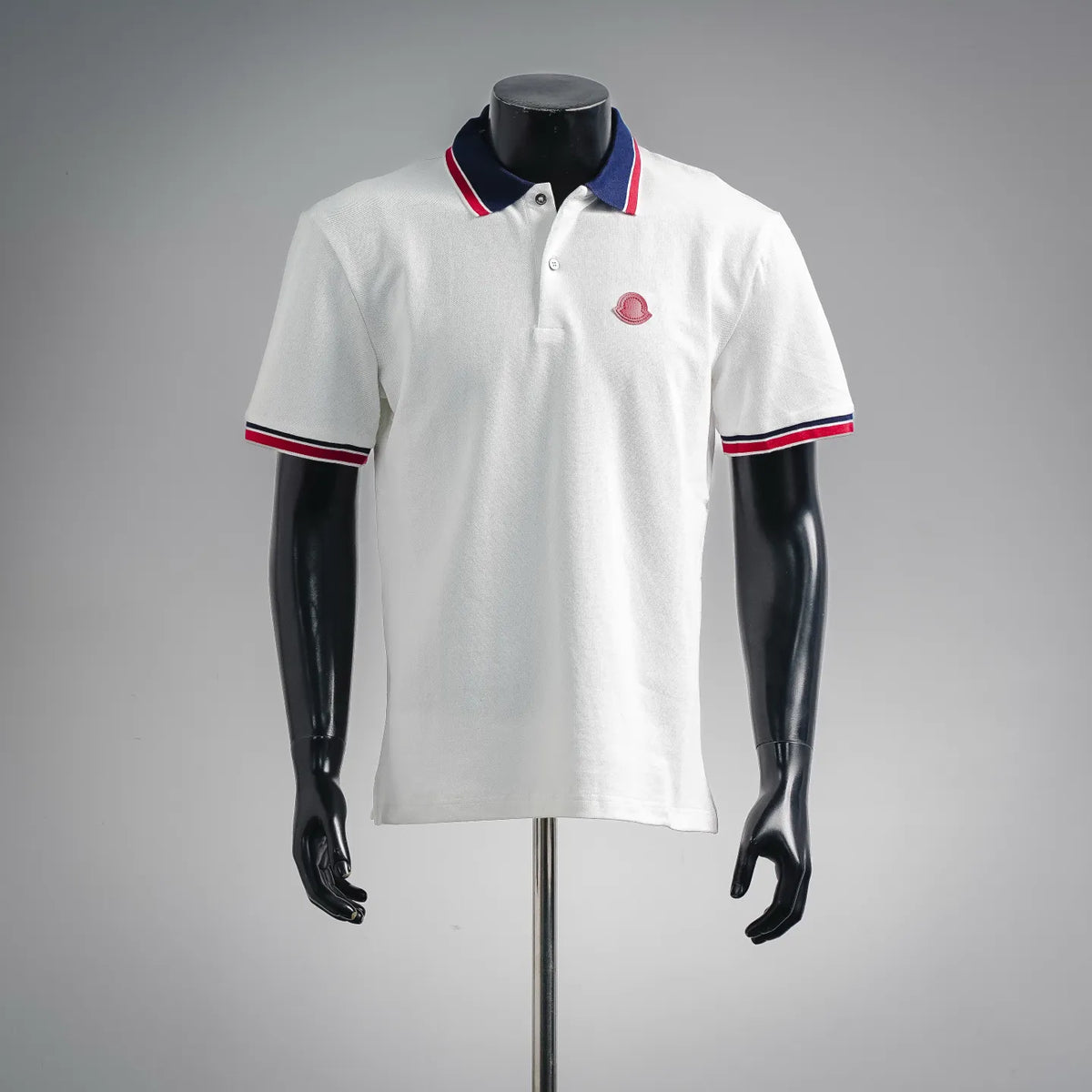 White short-sleeve polo shirt with navy collar and red/white striped trim
