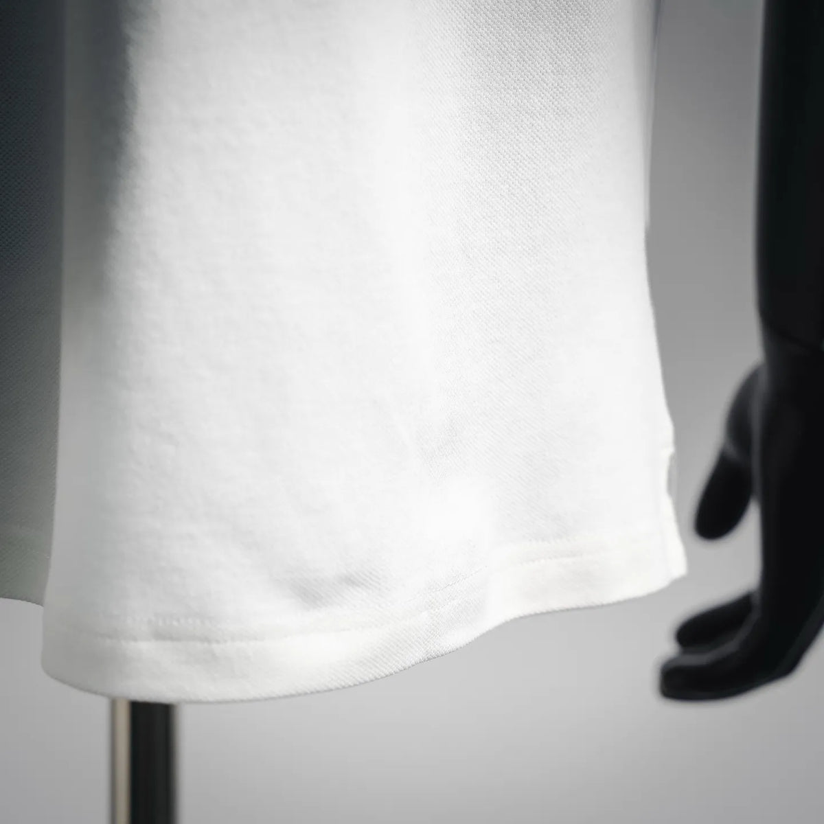 White polo shirt fabric close-up at the hem