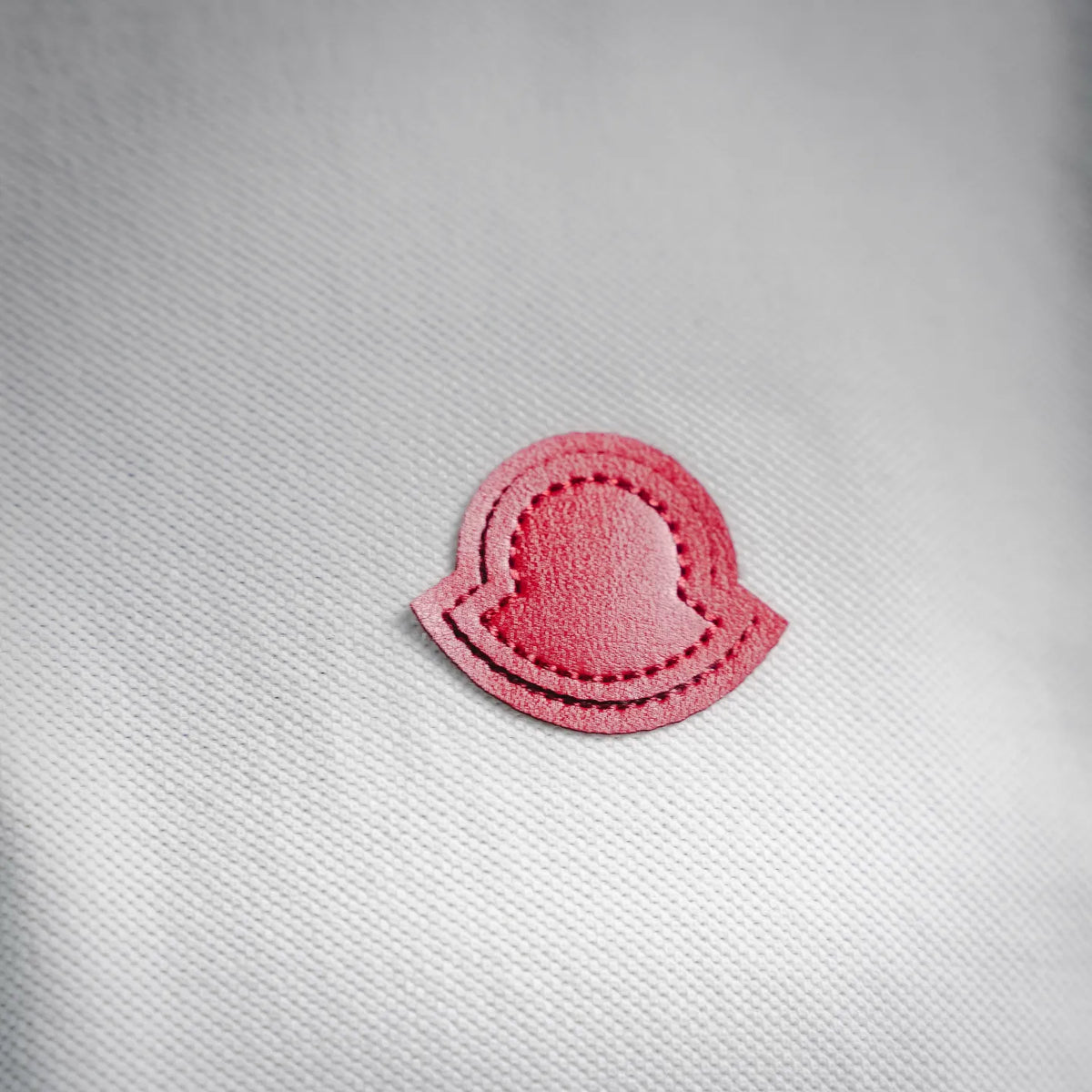Red heart logo patch on white polo shirt