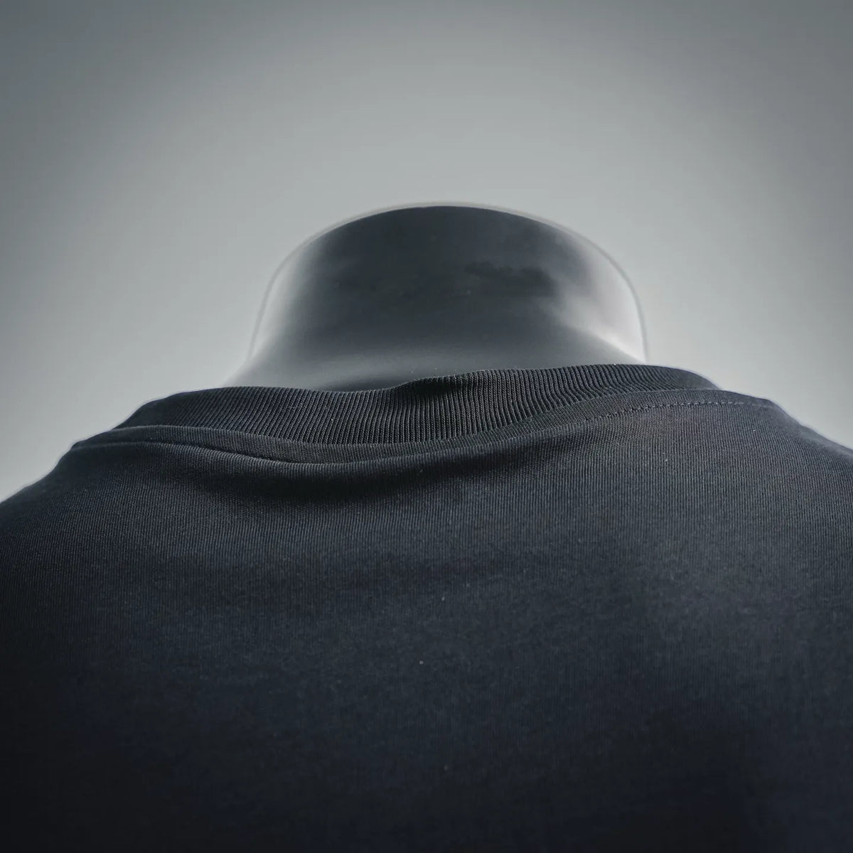 Dark crew-neck T-shirt collar with ribbed trim close-up