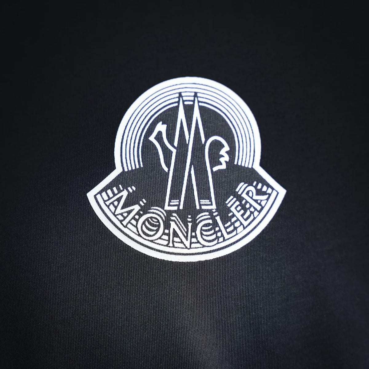 Moncler logo graphic on dark T-shirt chest