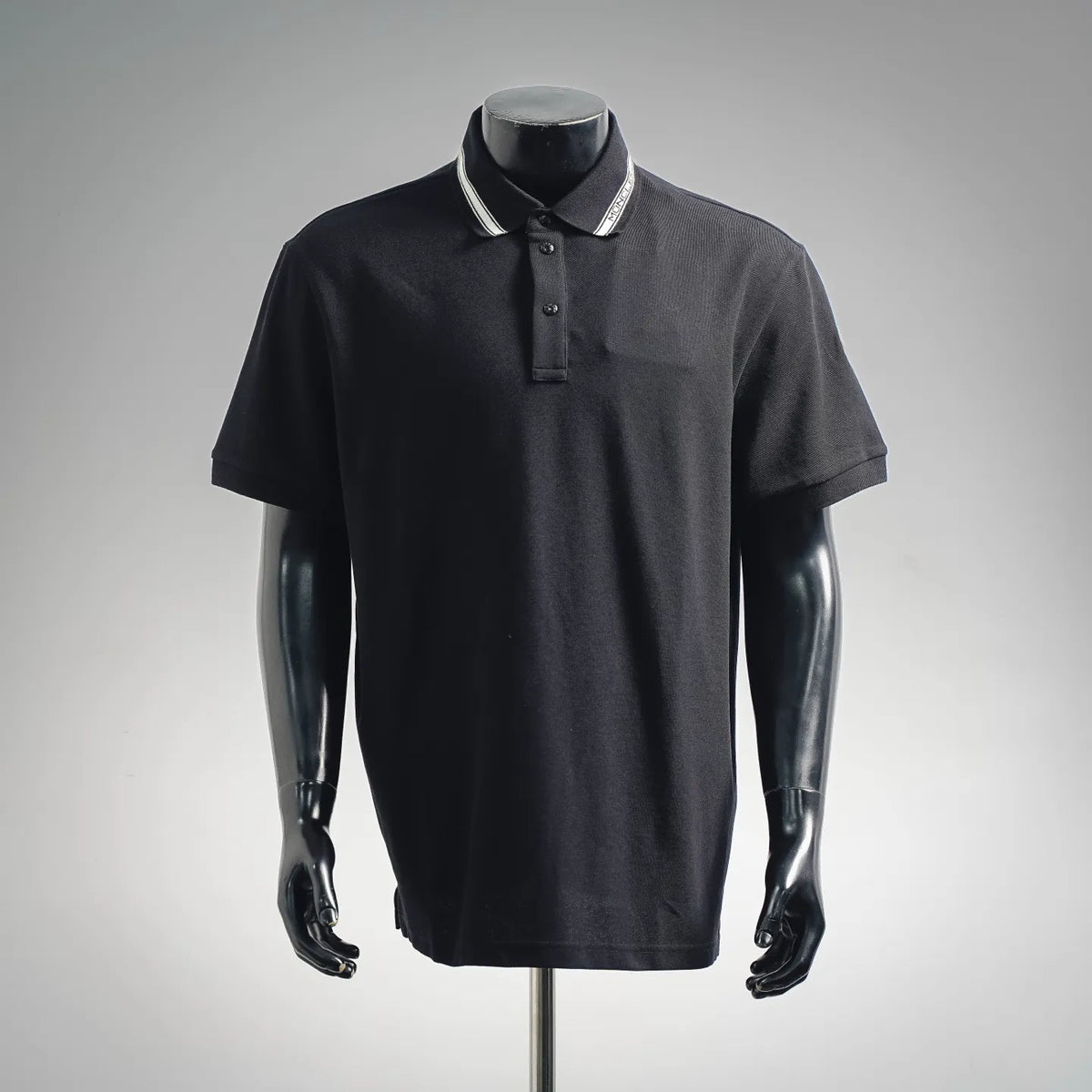 Dark polo shirt with ribbed striped collar and button placket, short sleeves