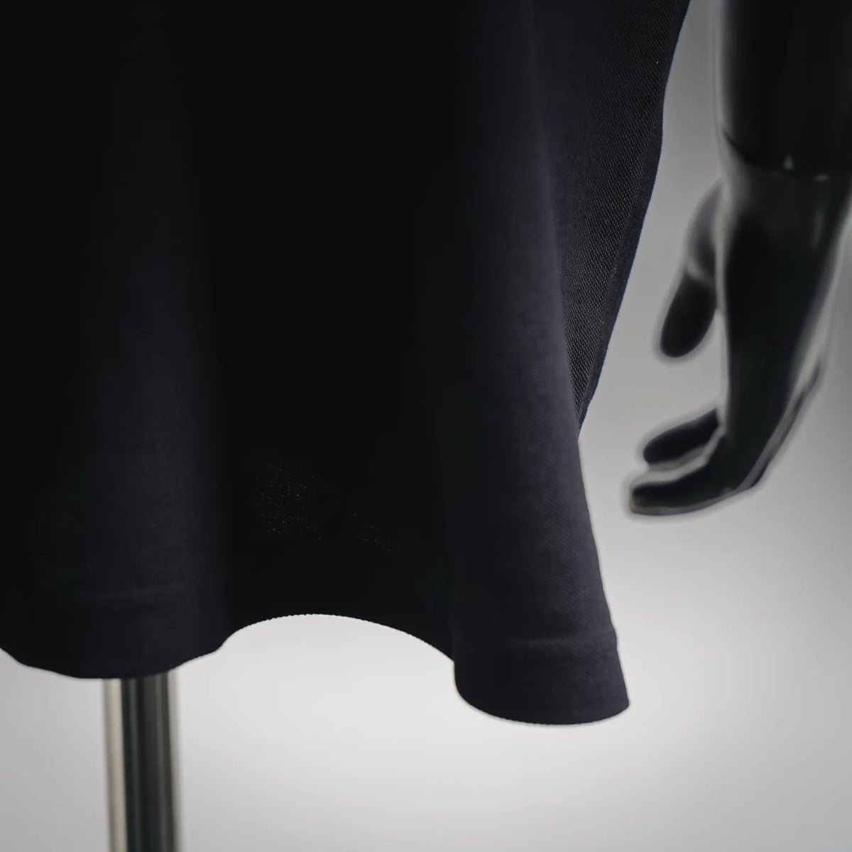 Dark polo shirt hem with curved bottom and side slit
