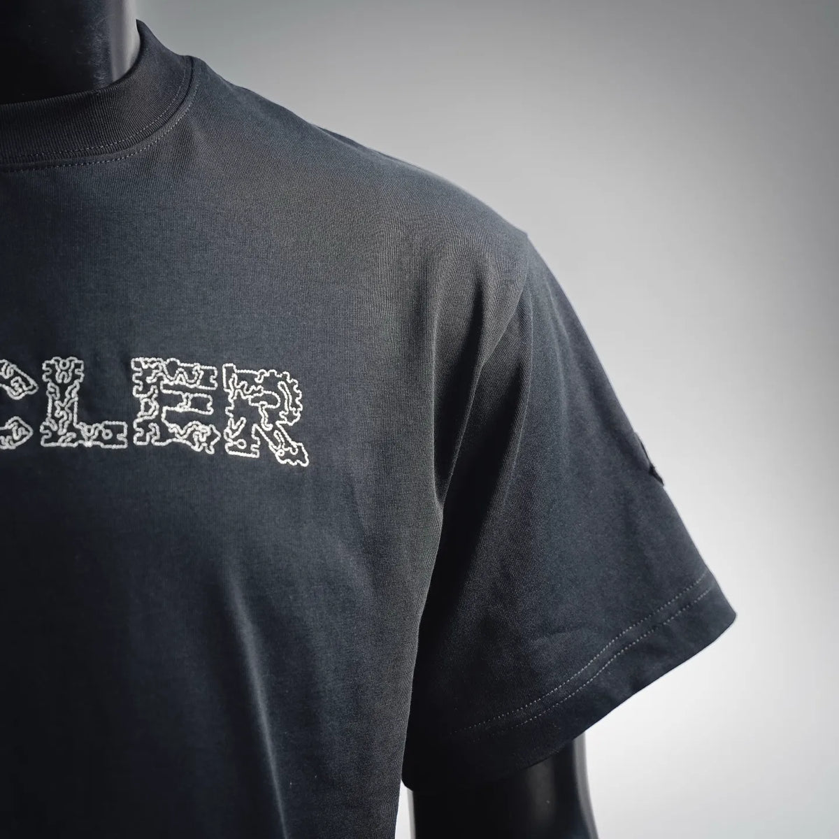 Moncler dark T-shirt sleeve with partial white logo graphic