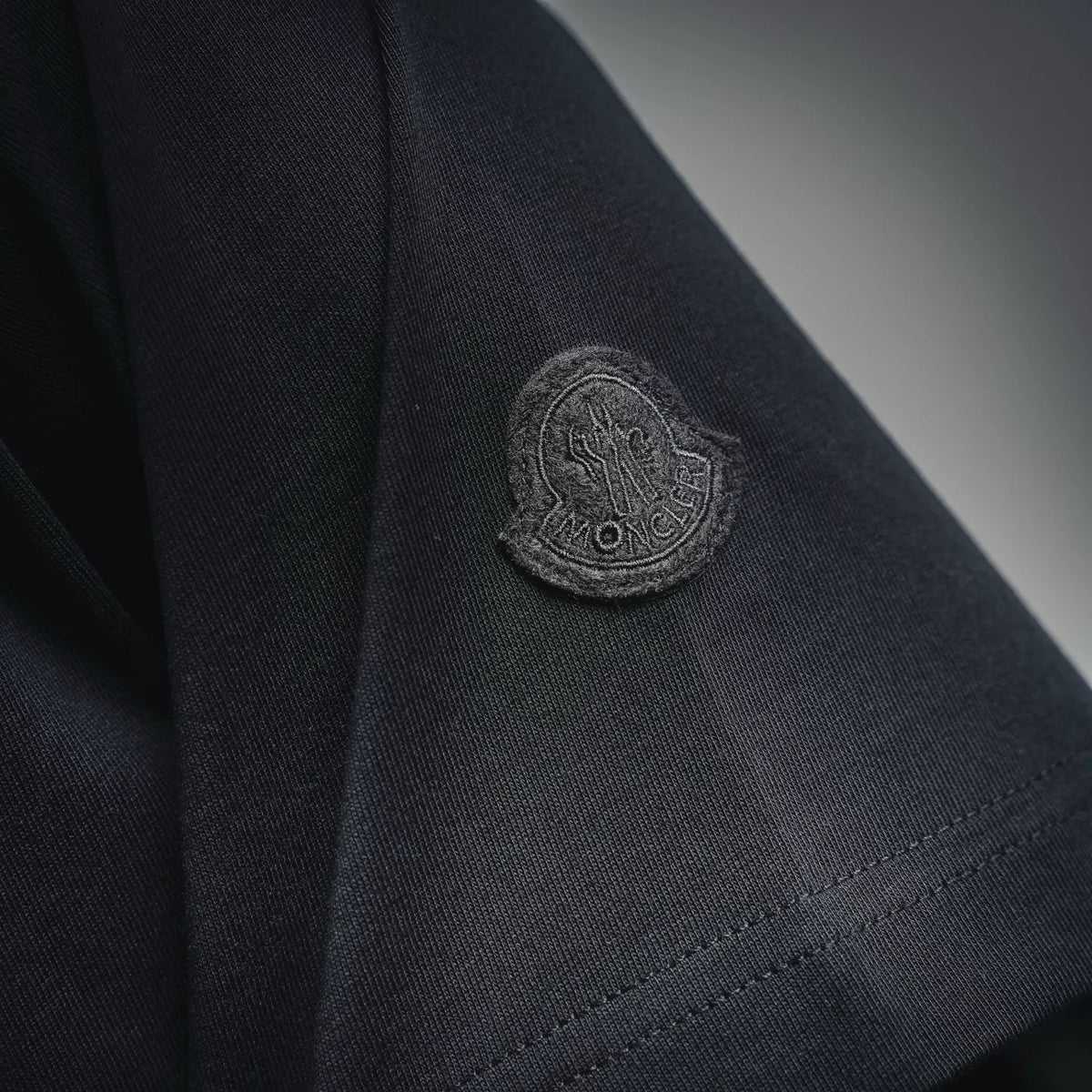 Moncler dark T-shirt with circular sleeve logo patch