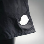 Moncler black swim shorts with round white logo patch near hem